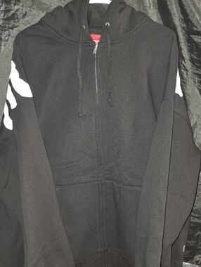 Supreme x Thrasher Zip Up Hooded Sweatshirt in black, featuring a cross graphic